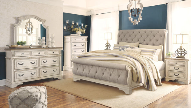 Ashley Realyn - Two-tone - 7 Pc. - Dresser, Mirror, California King Upholstered Sleigh Bed, 2 Nightstands